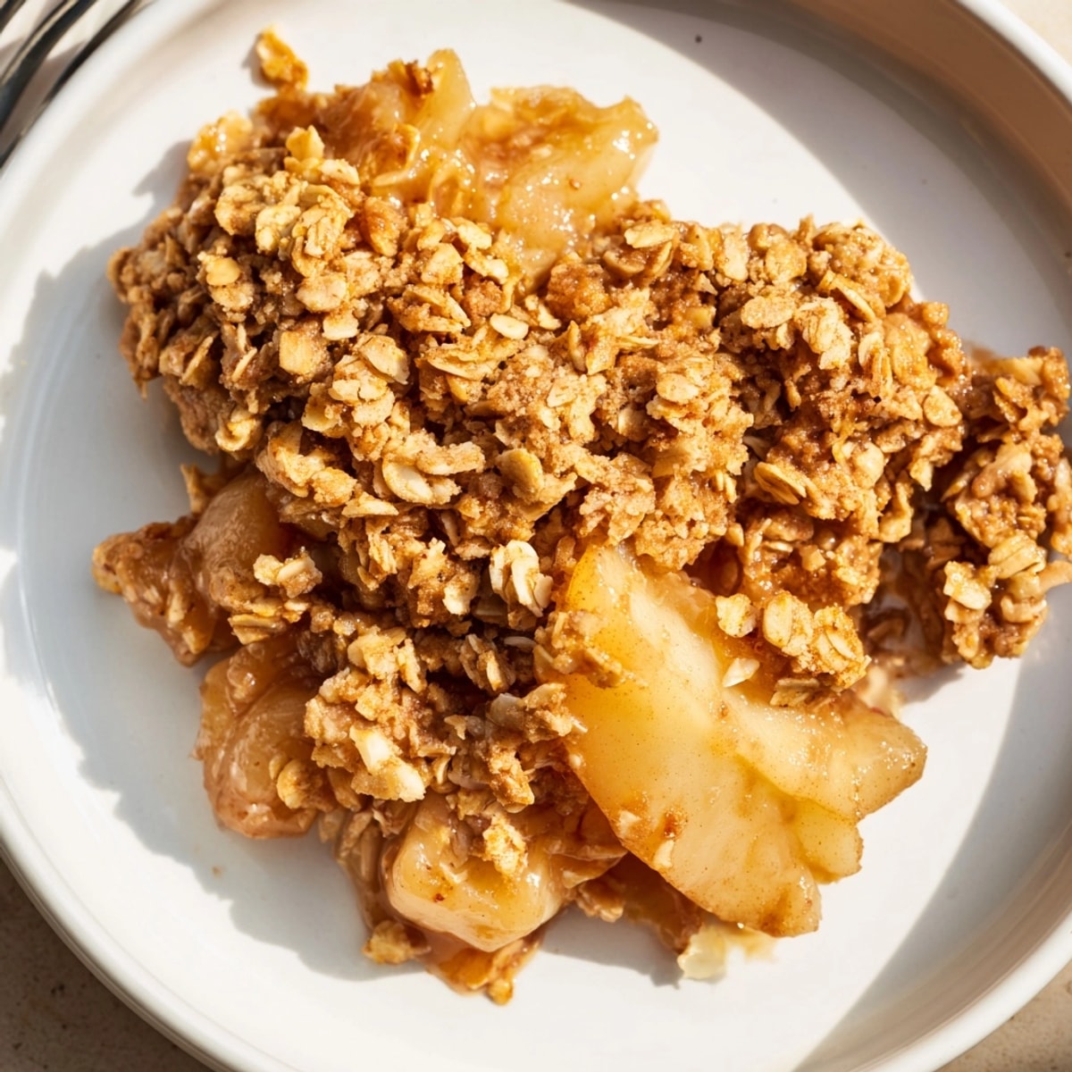 Buttery oat crumble topping covers the spiced Cinnamon Caramel Pear Crumble, fresh from oven.