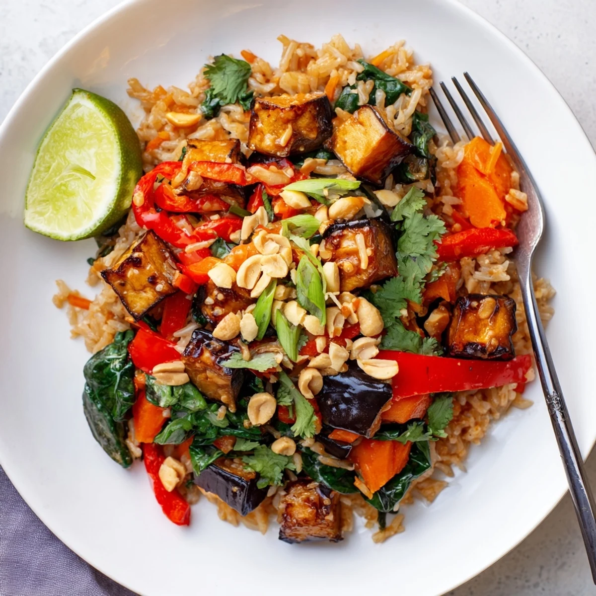 Vibrant Thai Peanut Eggplant Rice Bake layered with colorful veggies and aromatic spices.  