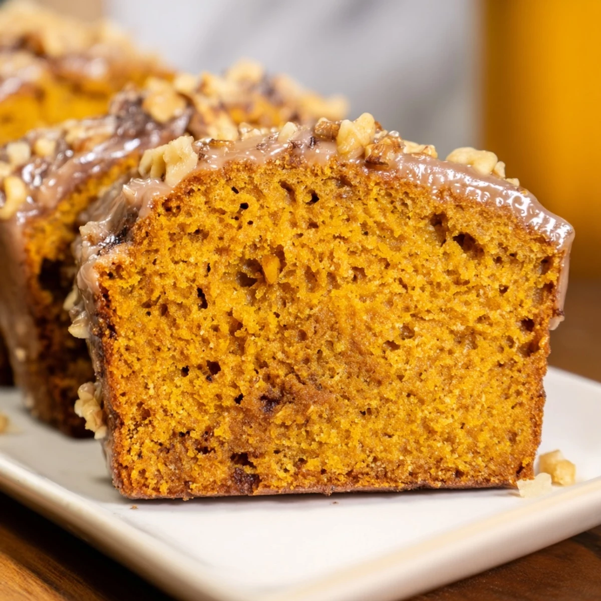 Warm, spiced pumpkin bread loaf, golden brown and delicious, ready for a fall snack.