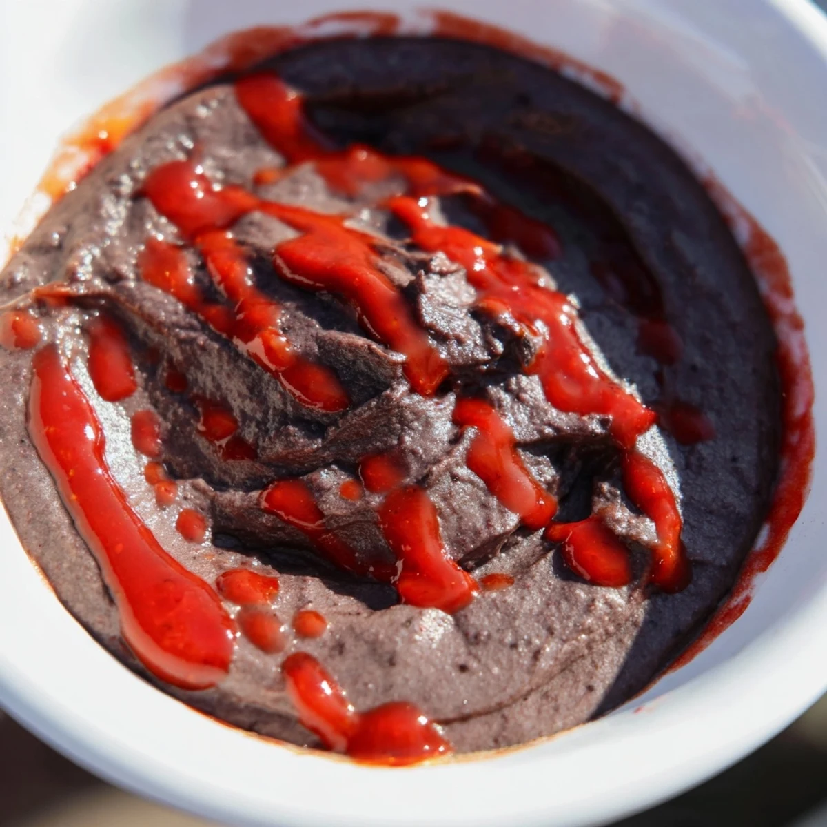 A flavorful, zesty black bean dip, easily made with salsa and hot sauce, ready to serve.