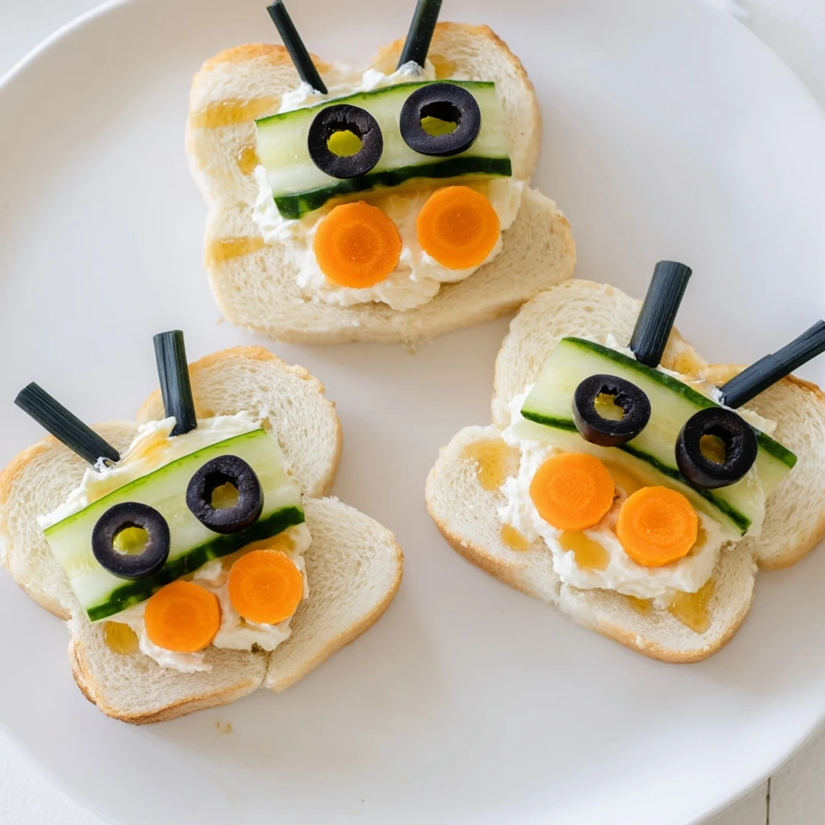 Bee sandwich cutouts on a board, with vibrant fruit and veggie sides, perfect for kids.