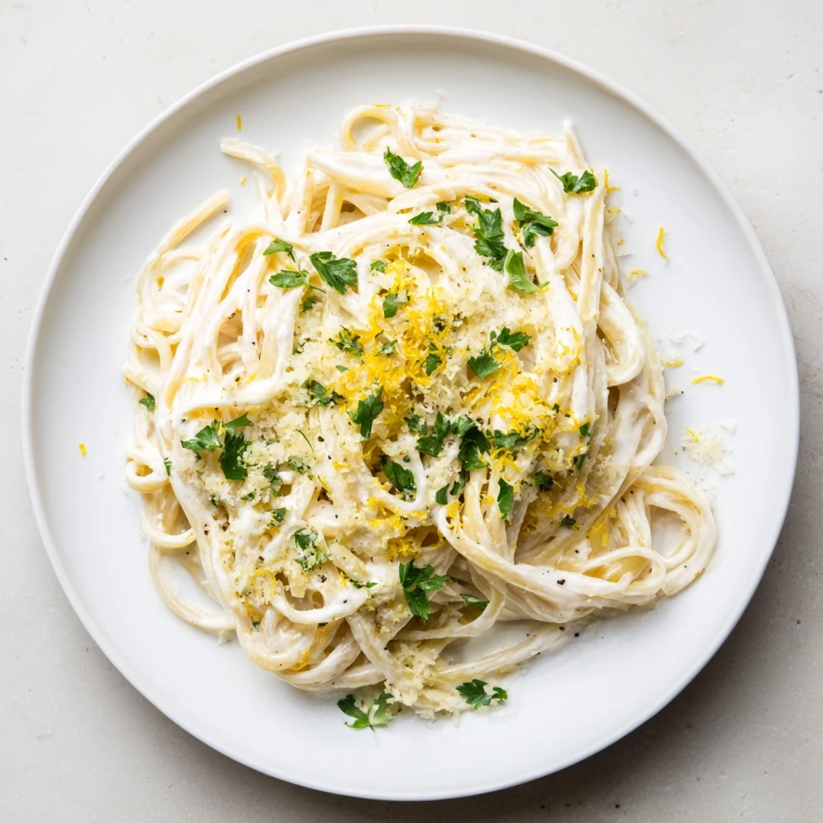 Creamy Lemon-Garlic Greek Yogurt Pasta, ready to eat alongside fresh parsley and a lemon slice.