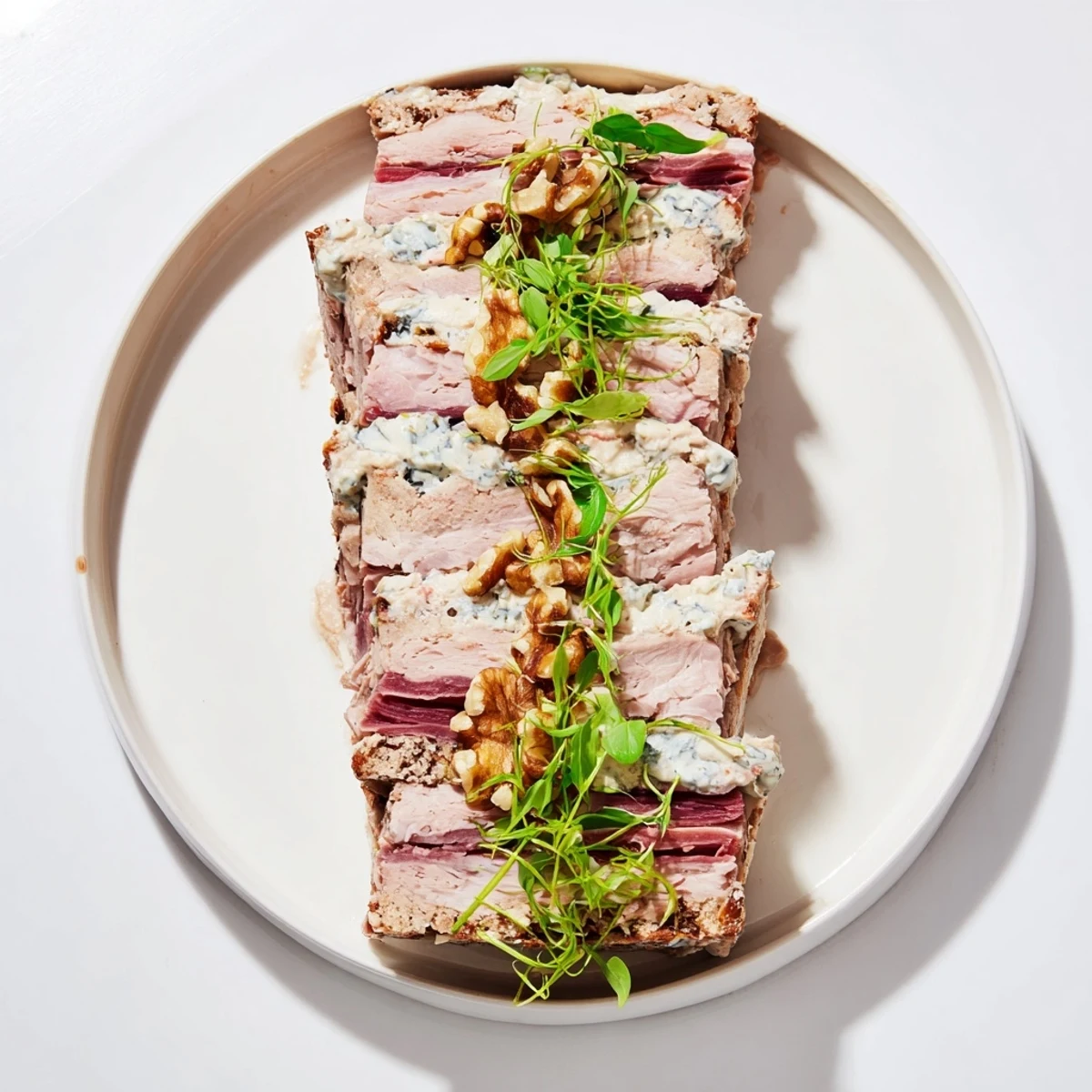 A cross-section reveals layers in this Grand Canyon Rim terrine, showcasing blue cheese river and meats.