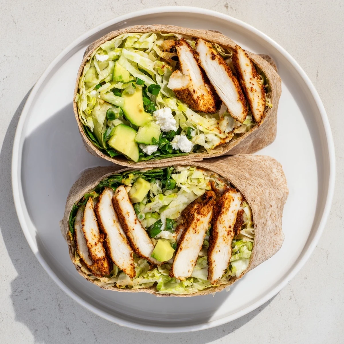 A delicious Green Goddess Chicken Wrap, filled with grilled chicken and vibrant fresh salad.