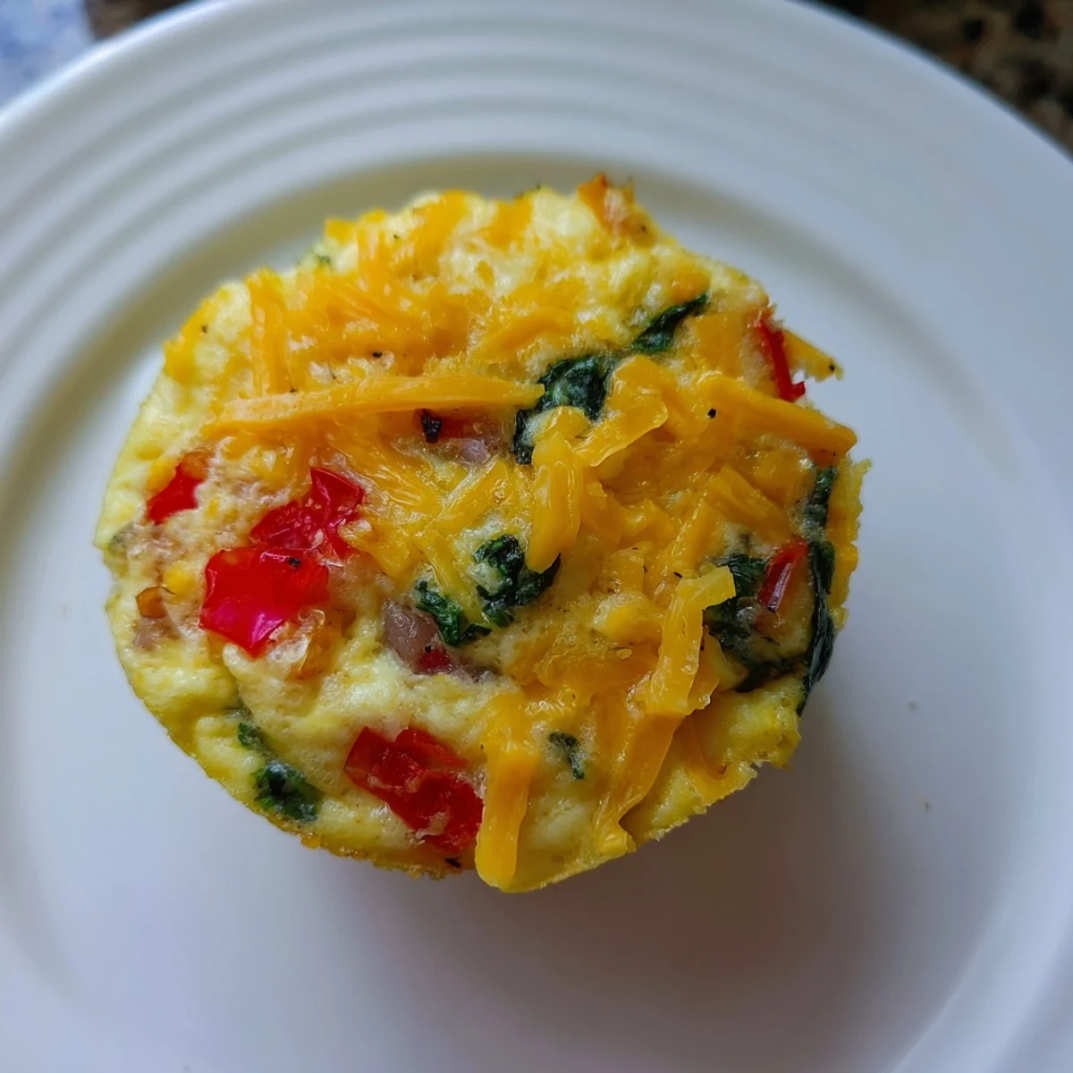 View the delicious, fluffy texture of these perfectly baked Customizable Egg Muffins just out the oven.