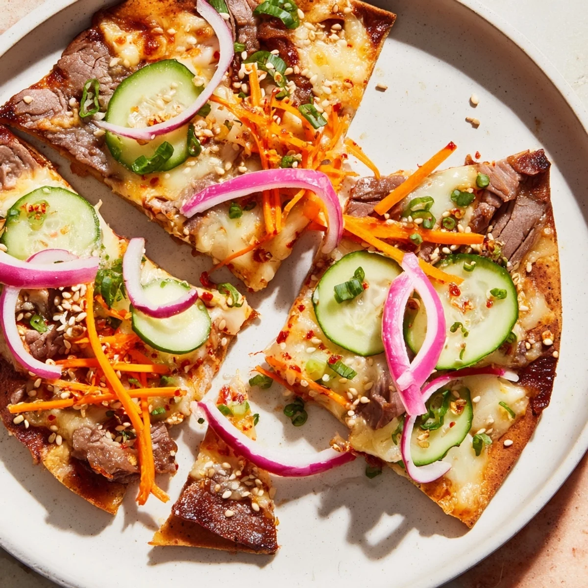 Savory Korean BBQ nachos feature tender beef, fresh vegetables, and melted cheese, perfect for sharing.