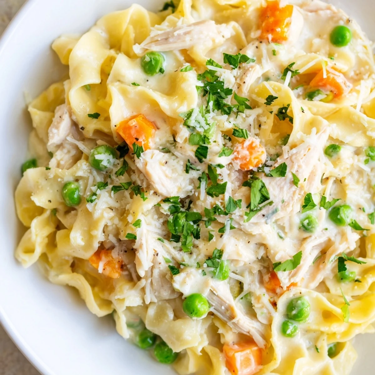 Warm spring chicken noodle skillet, a creamy comforting meal with tender chicken and veggies.