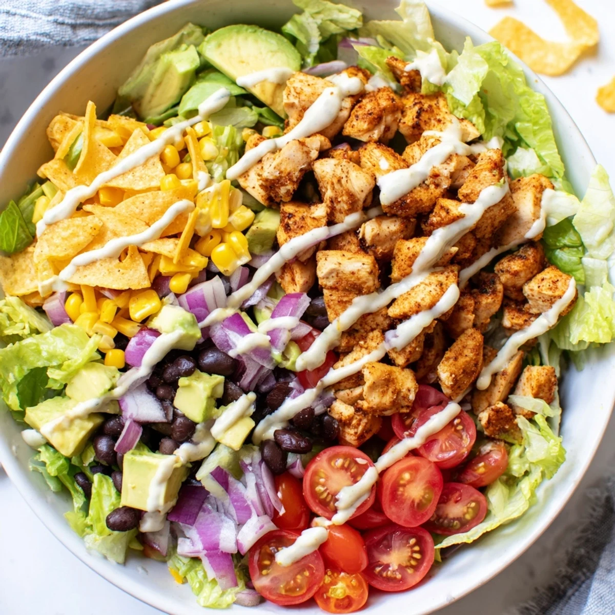 Chicken Taco Chopped Salad loaded with seasoned chicken, fresh veggies, and creamy salsa ranch.