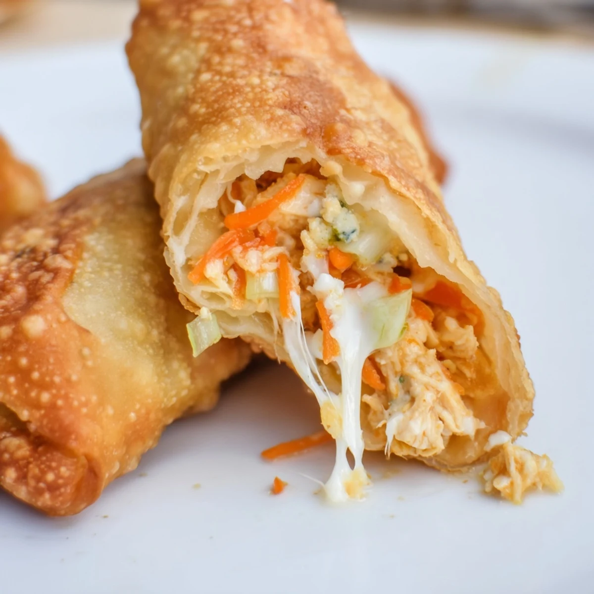 Spicy shredded chicken, carrots, and celery fill these crunchy Buffalo Chicken Egg Rolls, ready for game day.