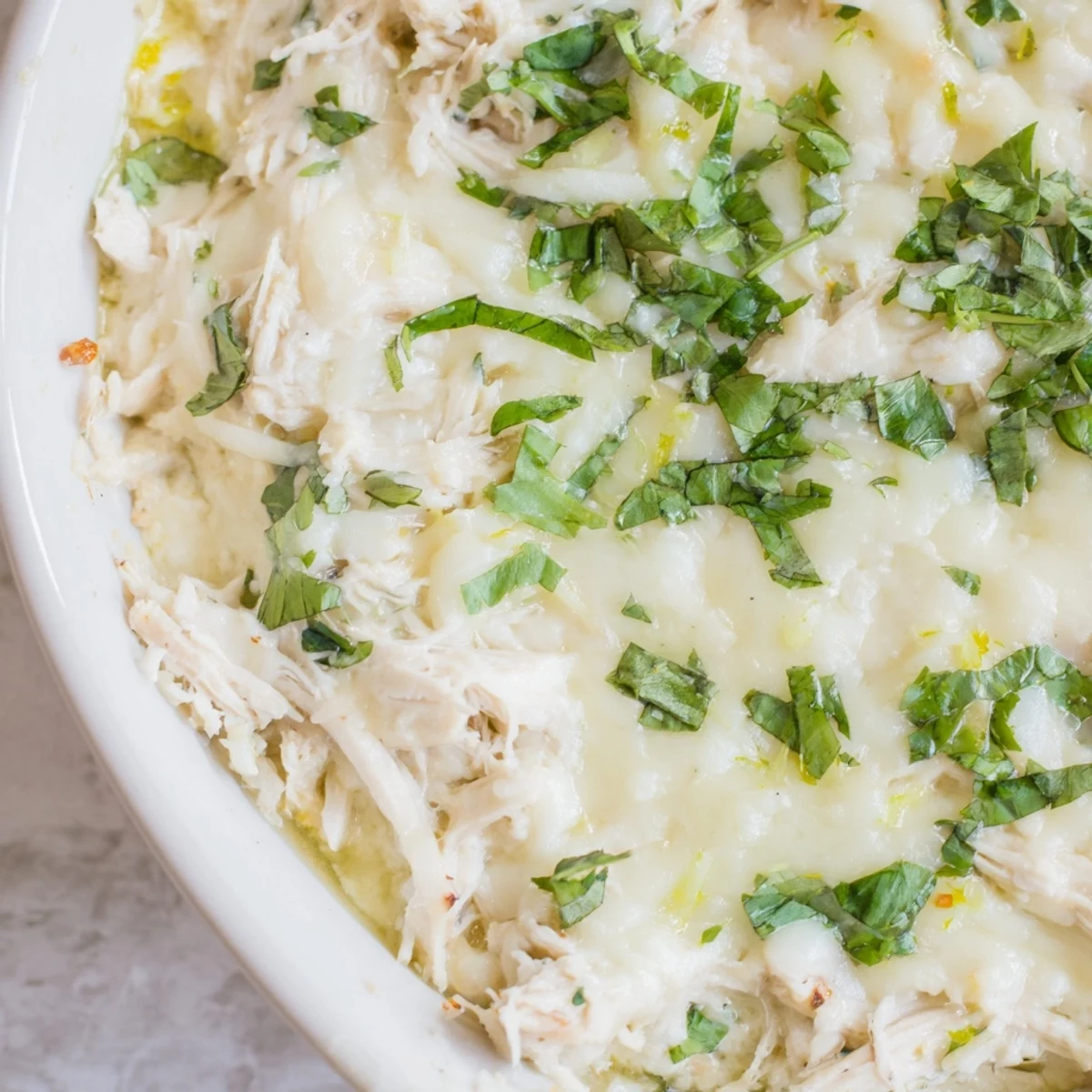 Cilantro and Lime Chicken With Scoops bubbling from the oven, highlighting the vibrant green cilantro and bright lime garnish on a serving platter.