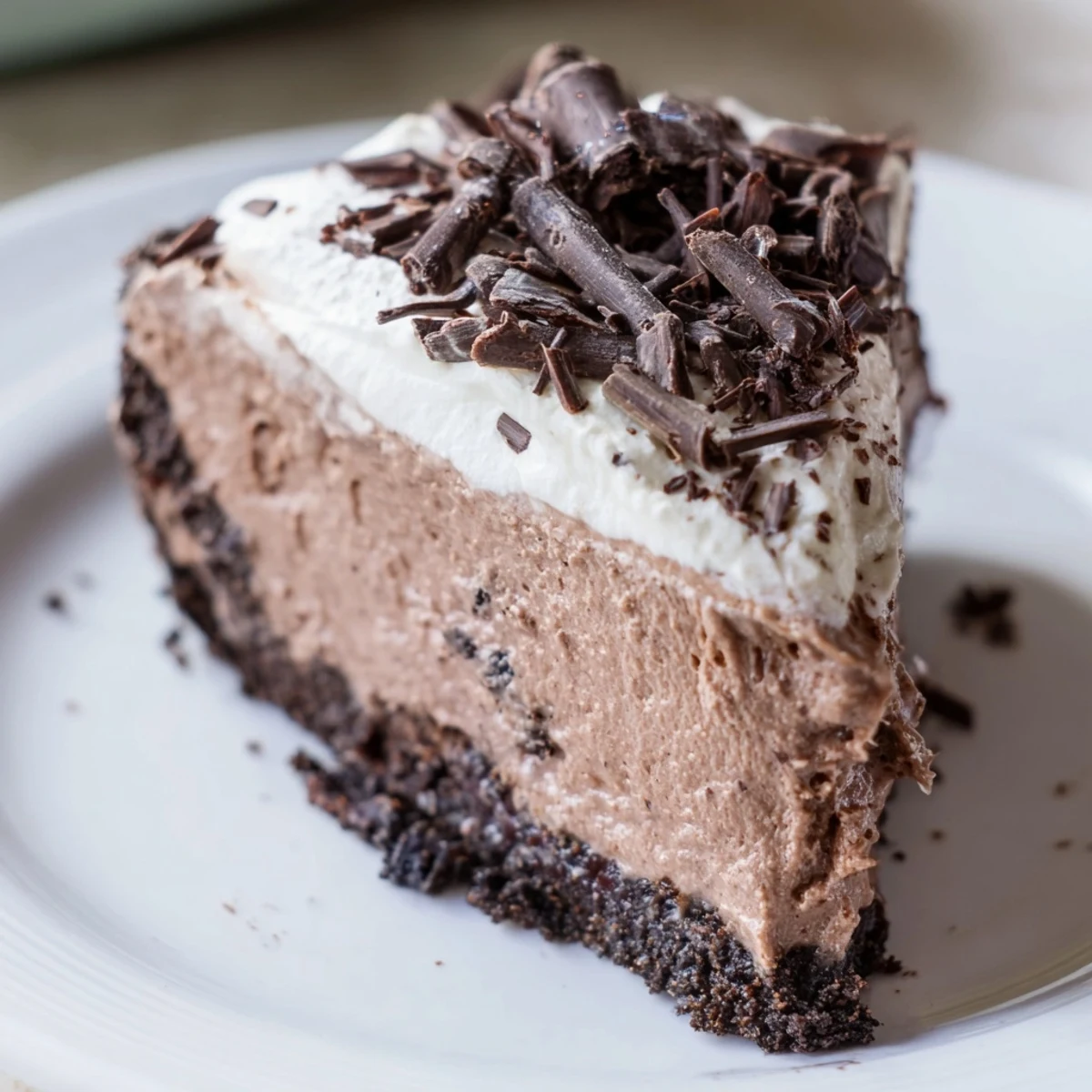 A perfectly set slice of Lighter Chocolate Cottage Cheese Cheesecake, featuring a rich, dark cocoa filling on a crumbly graham cracker crust.  