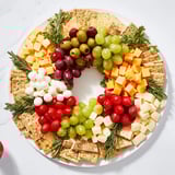 Fresh mozzarella and cheddar cubes mingle in this holiday Jingle Bell Cheese & Cracker Wreath, ready to serve!
