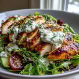 Fresh, healthy low calorie high protein chicken salad topped with juicy cherry tomatoes, cucumber slices, and zesty herb dressing.  