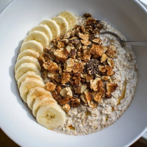 Hearty Protein Cinnamon Crunch Oatmeal topped with nuts and fresh fruit.  