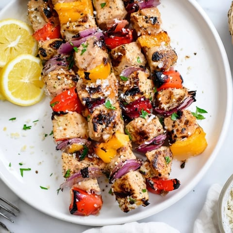 Juicy Garlic Parmesan Chicken Kabobs grilled to perfection, served with vibrant veggies.  