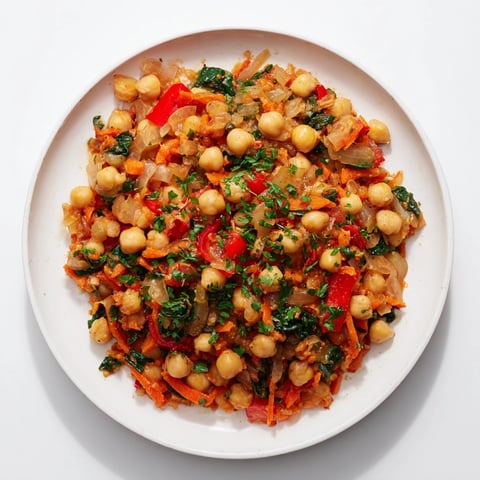 A steaming skillet of Vegetarian Chickpea & Spinach, a healthy one-pan meal, colorful and aromatic.
