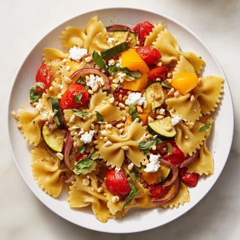 Vivid Festive Bow Tie Pasta Platter, boasting colorful roasted vegetables and creamy feta cheese, ready to serve!
