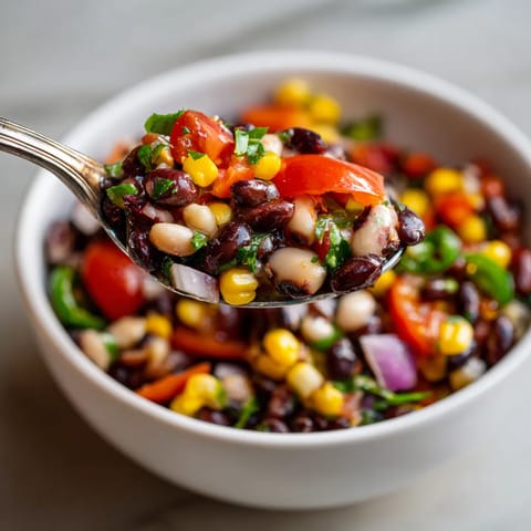 A bowl of food with a spoon in it.