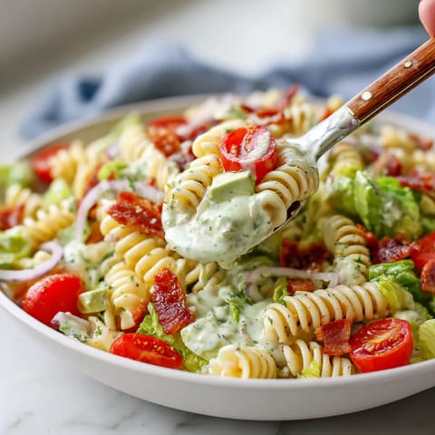 A fork is being used to pick up a piece of food from a bowl.