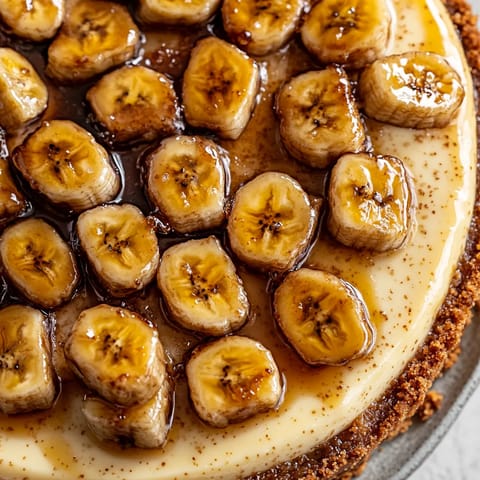 A slice of caramelized banana cheesecake with rum glaze.