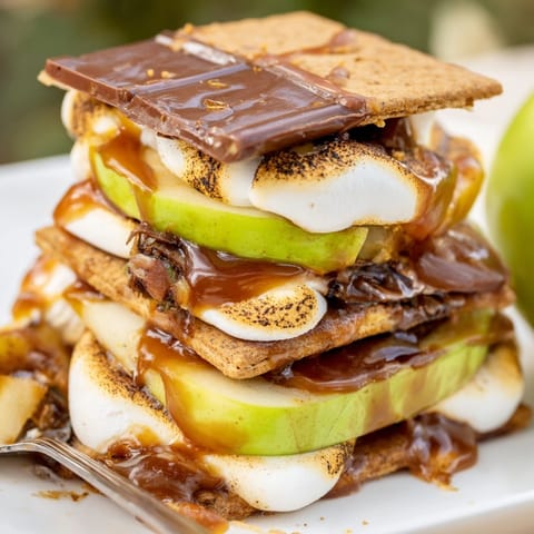 Layered Caramel Apple S’mores Stack: graham crackers, melted chocolate, sticky caramel, and tart apples.