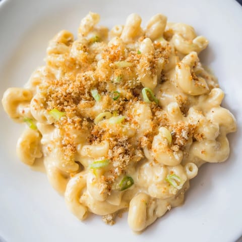 Creamy, cheesy Katsu Curry Mac &amp; Cheese, ready to be served with fresh toppings.
