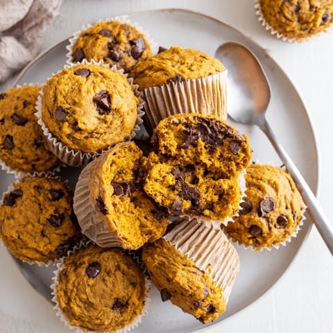 Deliciously spiced pumpkin chocolate chip muffins, perfect for a warm breakfast delight.  