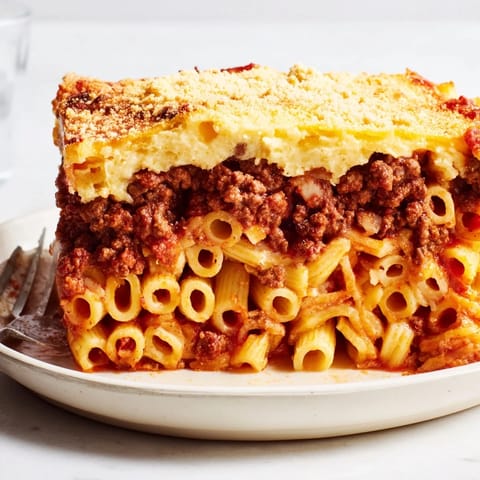 Golden-baked Pastitsio topped with creamy béchamel, perfect for family dinners.  