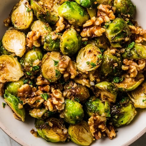 Crispy roasted Brussels sprouts coated in a sweet maple glaze and walnuts.  