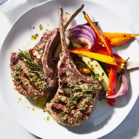 Tender lemon herb lamb chops served with vibrant roasted vegetables for a delicious dinner.  