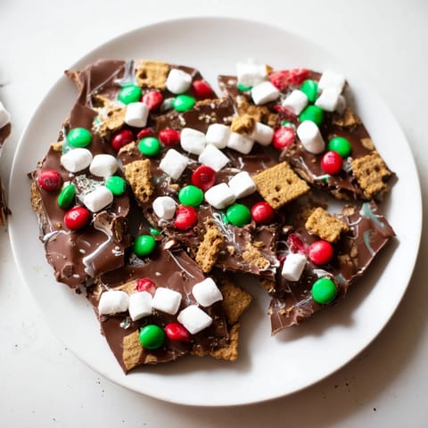 Enjoy the delicious crunch of graham crackers in this Quick Christmas Smores Bark, perfect for a cozy treat.