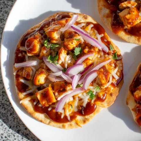 Warm BBQ Chicken Flatbread, a delightful American comfort food with juicy chicken and cheddar cheese.