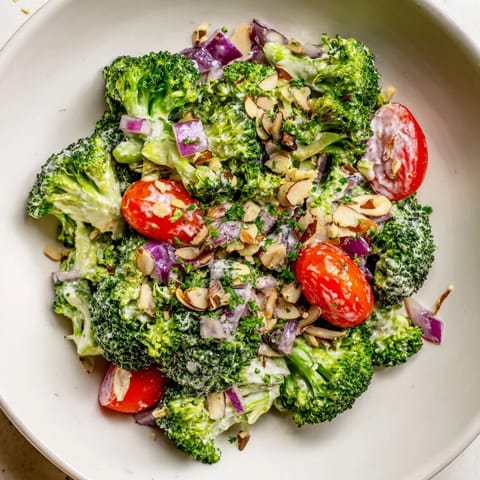 Freshly tossed Garlic Parmesan Broccoli Salad with toasted almonds, a flavorful and easy recipe.