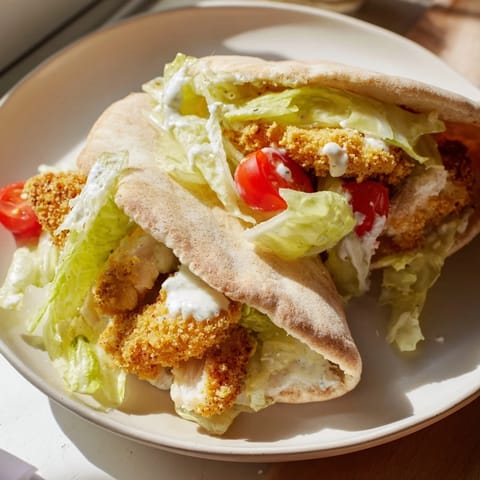 This Crispy Chicken Caesar Pita features flavorful chicken, creamy dressing, and Parmesan, a delicious handheld meal.