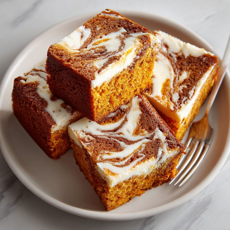 A plate of cake with white frosting and swirls.