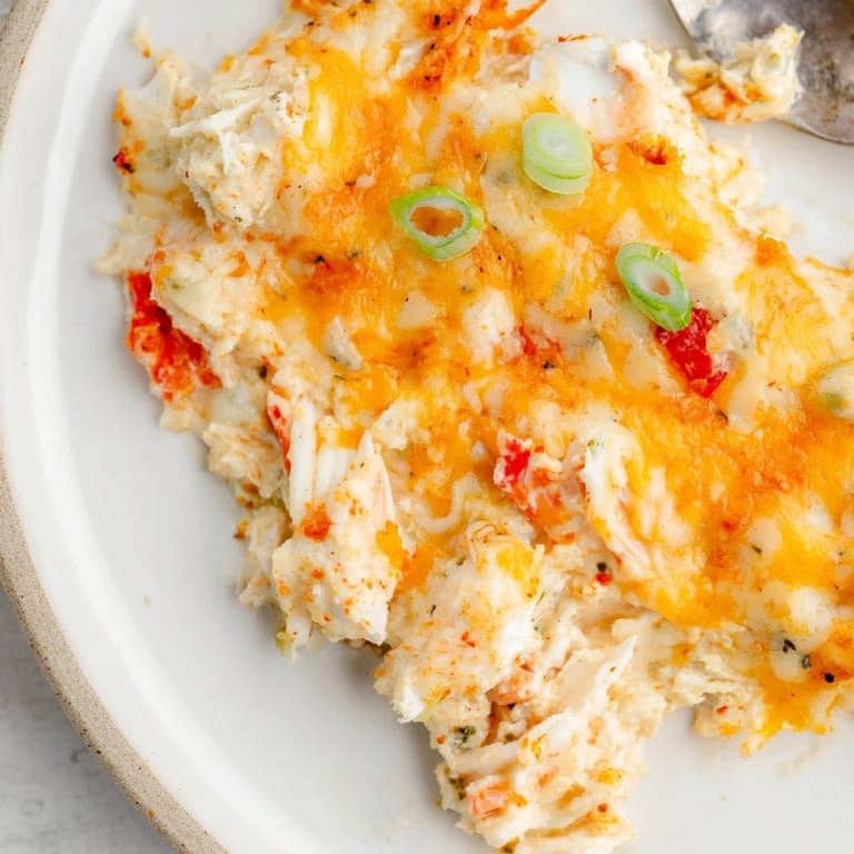 Creamy Cheesy Cajun Crab Dip served with crispy baguette slices for a delightful snack.