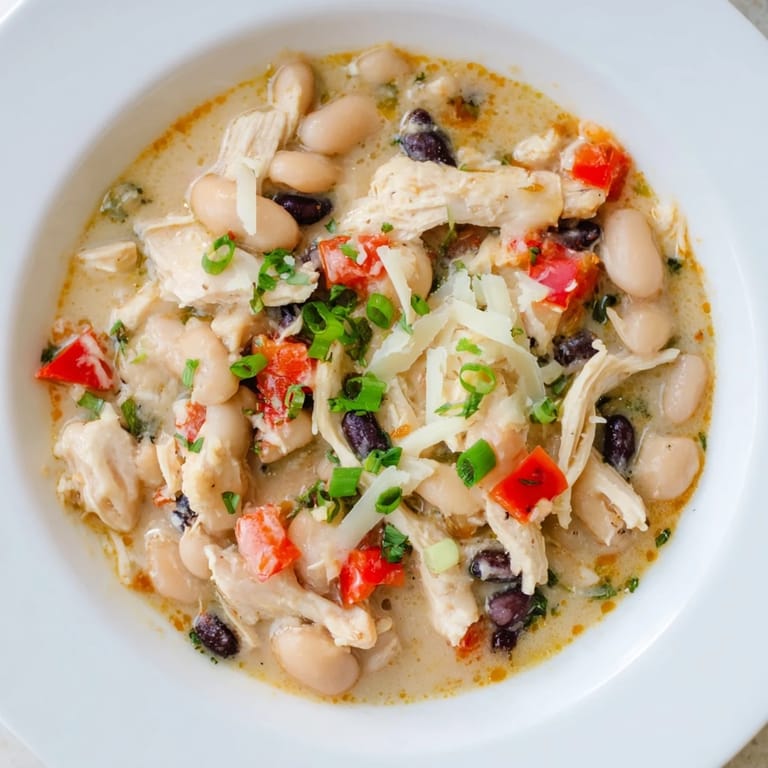 Close-up of a hearty slow cooker white chicken chili with black beans, perfect for a cozy dinner.