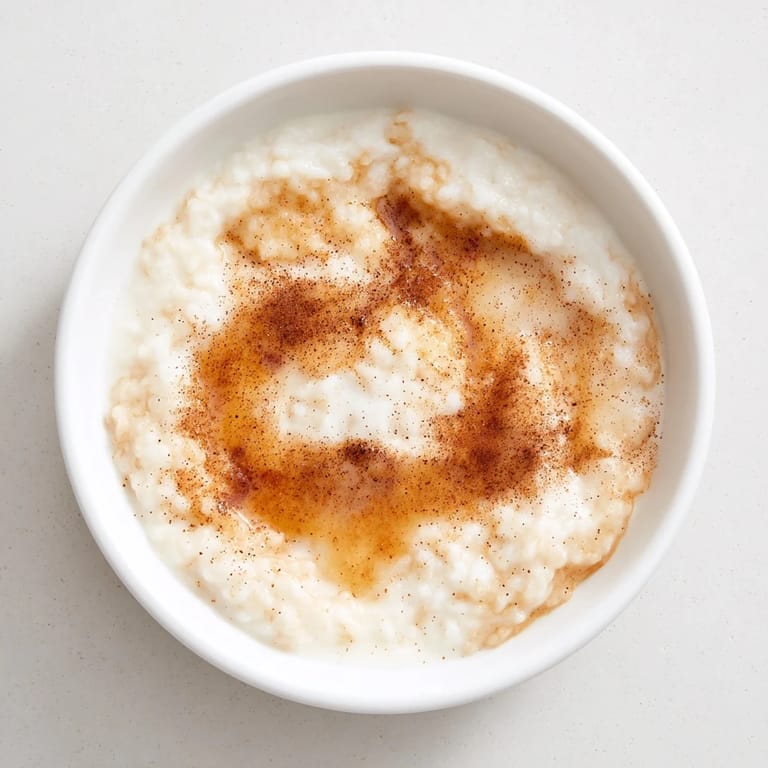 Warm, creamy rice pudding with leftover rice, topped with a dusting of fragrant cinnamon.