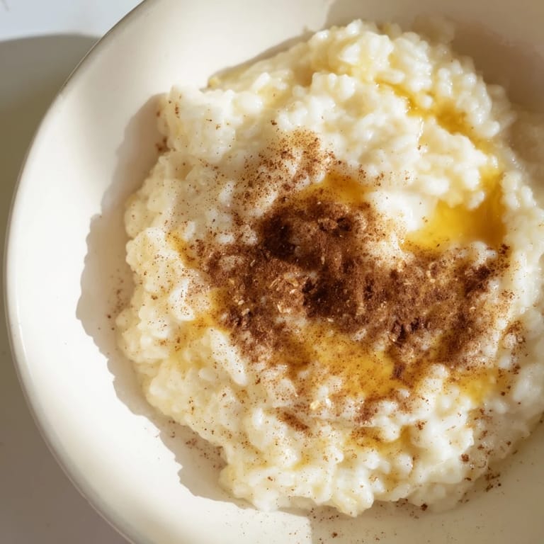 Close-up of a comforting bowl of rice pudding, made from leftover rice, ready to enjoy.