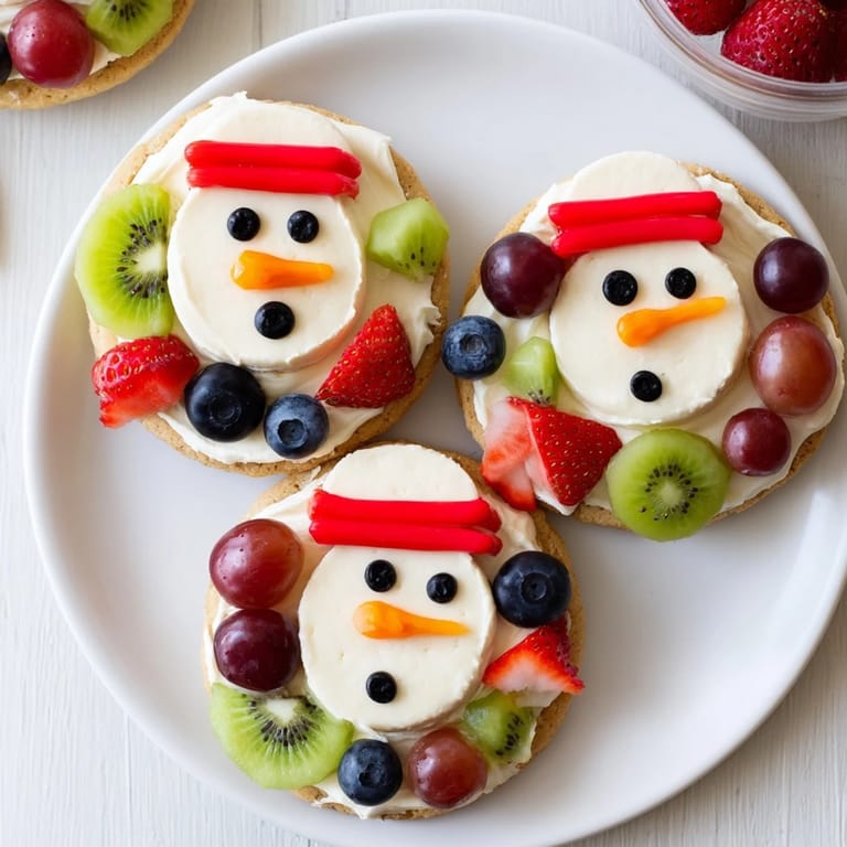 Enjoy a slice of homemade Melting Snowman Fruit Pizza, a sweet, inviting winter dessert.