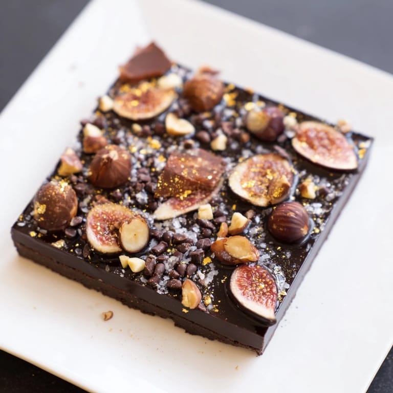 The Midnight Mosaic, featuring figs and olives, served chilled for a unique dessert experience.