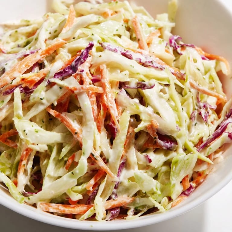 Crisp shredded vegetables tossed in a tangy, creamy Coleslaw With Creamy Dressing, ideal for summer barbecues and picnics.