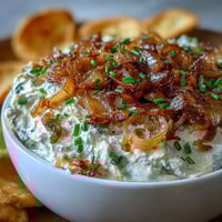 Creamy Caramelized Onion Dip with Greek Yogurt Base, featuring rich, golden caramelized onions blended into tangy yogurt for a savory appetizer.